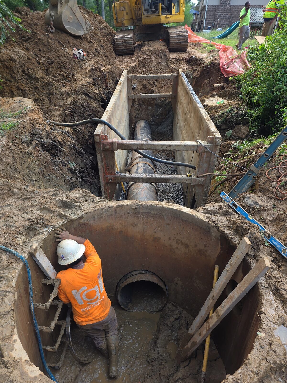 24-inch sewer main installation with manhole tie-in.