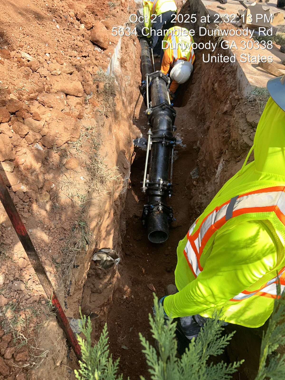 Water main installation in a residential right-of-way.