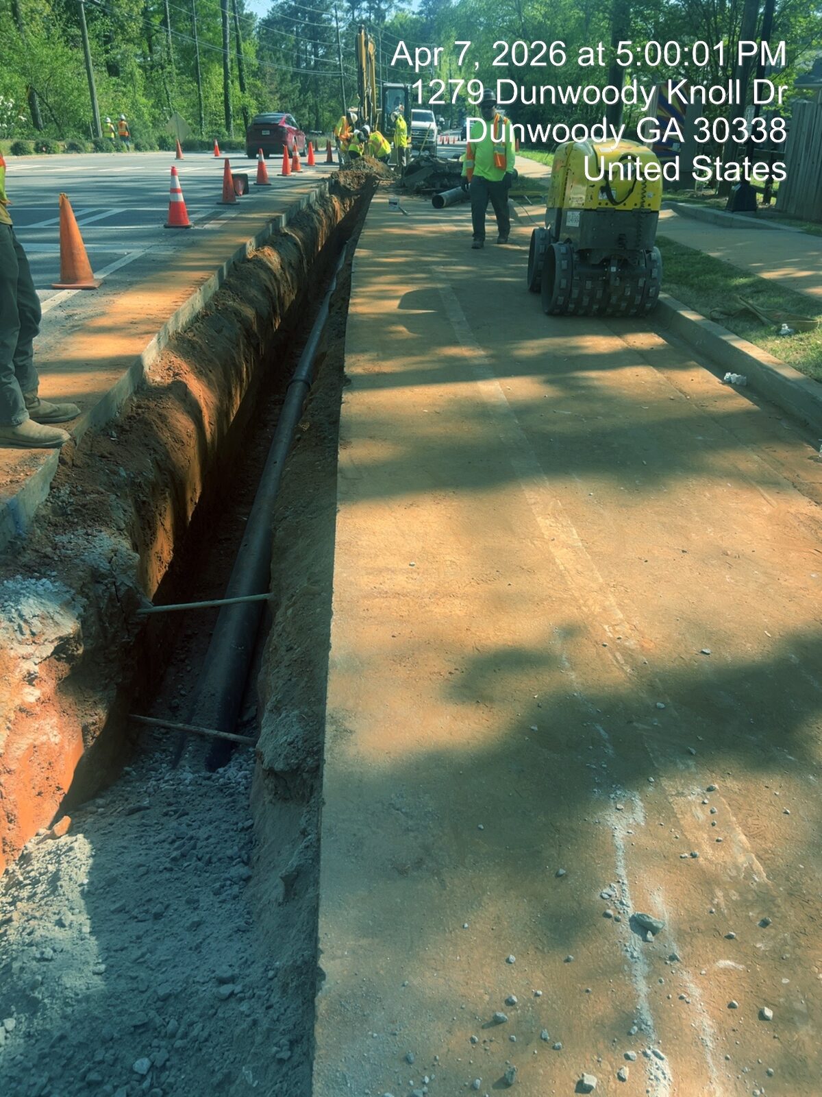 Open-trench water main installation, mid-cut.